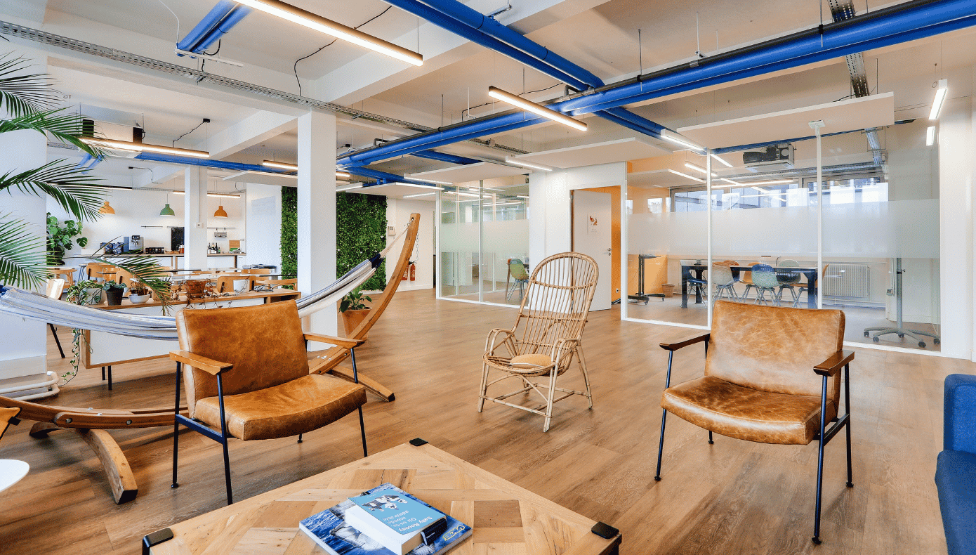 Espace lounge Hiptown Saint-Martin à Paris avec fauteuils, hamac et salles de réunion vitrées.